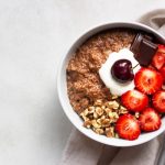 Chocolate,Oatmeal,Porridge,Topped,With,Strawberries,,Cherries,,Walnuts,And,Chocolate