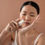 medium-shot-korean-woman-posing-with-serum_23-2150171925