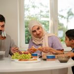 medium-shot-islamic-family-eating_23-2149887037