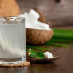 glass-coconut-water-put-dark-wooden-background_1150-28246